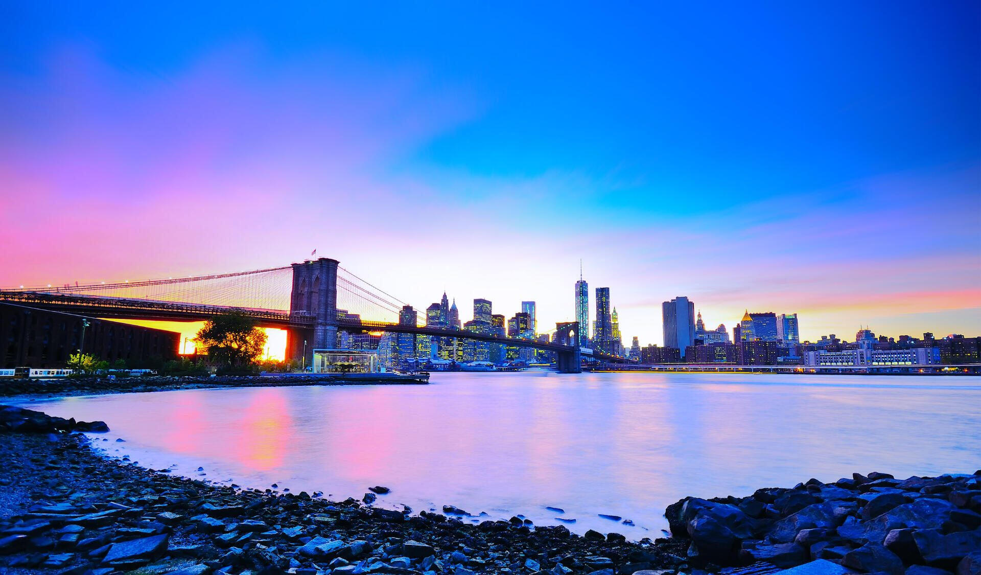 Brooklyn Bridge and the Manhattan skyline at sunset, seen from the Brooklyn waterfront